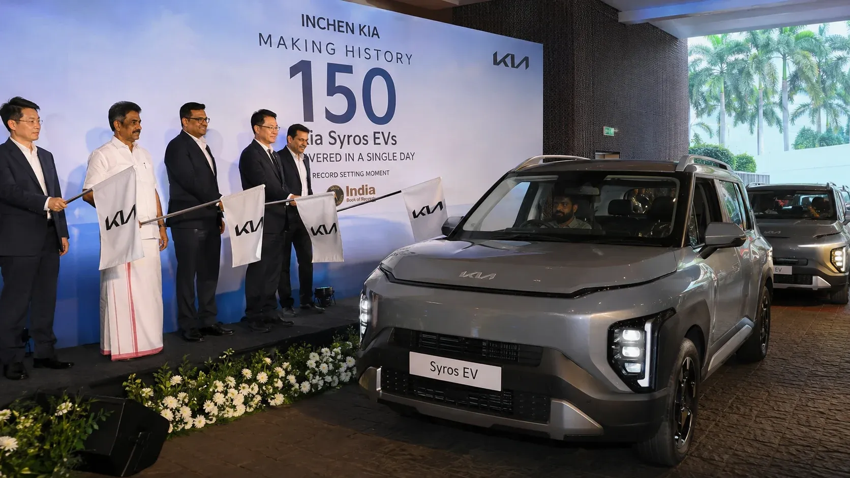 Kia Syros EV delivery event in Kochi where 150 electric SUVs were handed over in a single day.