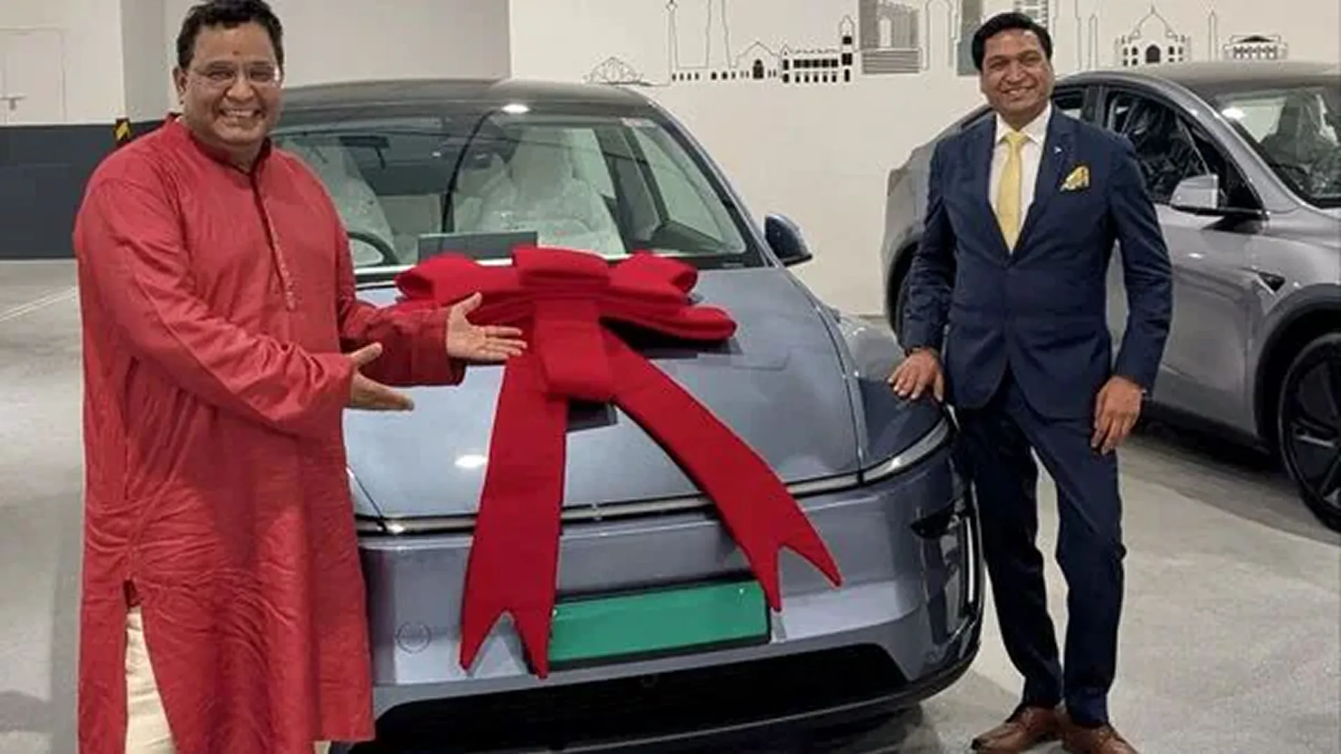 Vijay Shekhar Sharma, the CEO of Paytm, taking delivery of a Glacier Blue Tesla Model Y, from Sharad Agarwal, GM Tesla india