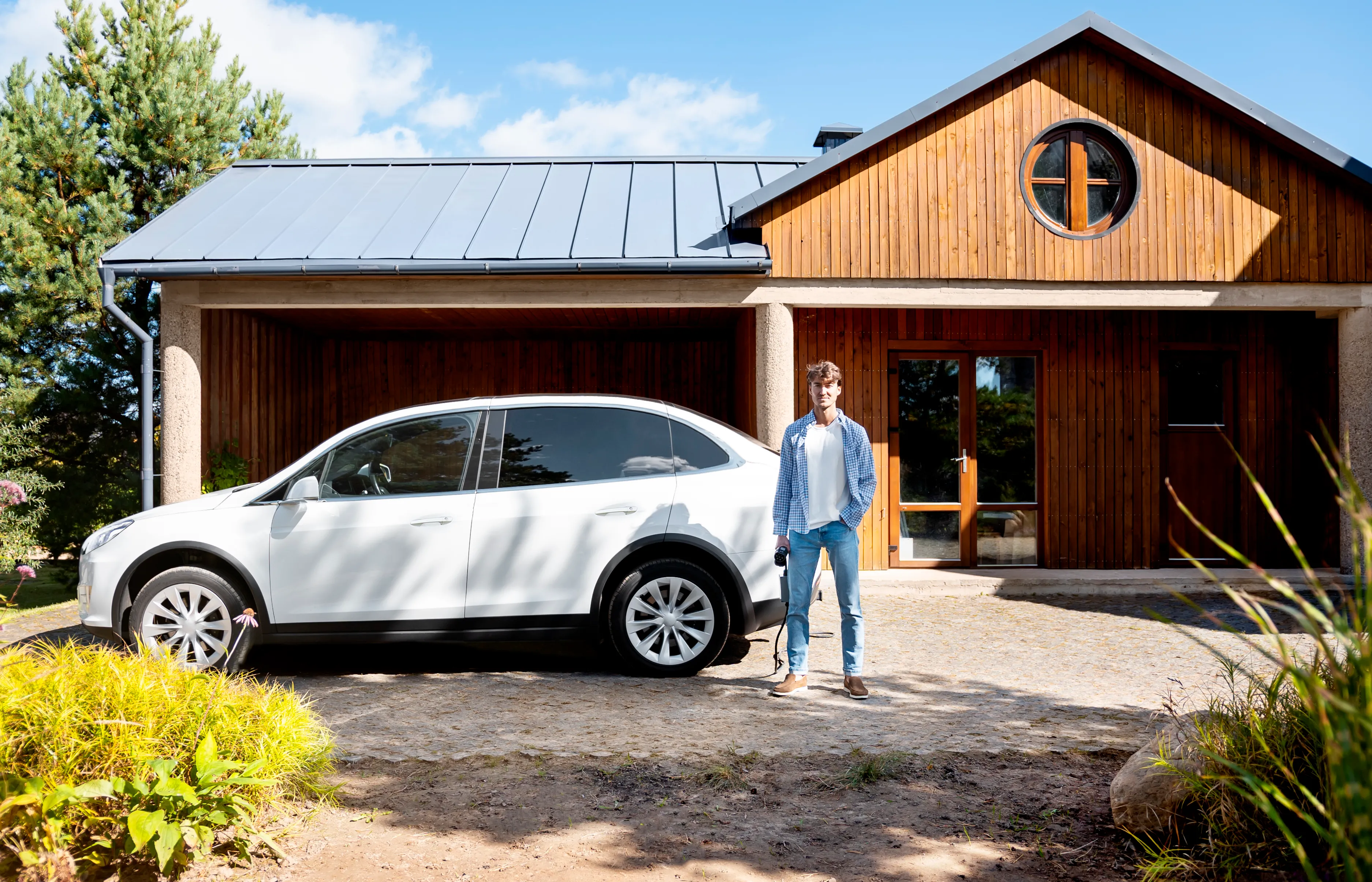 person taking care of electric car, with solar panels on the roof