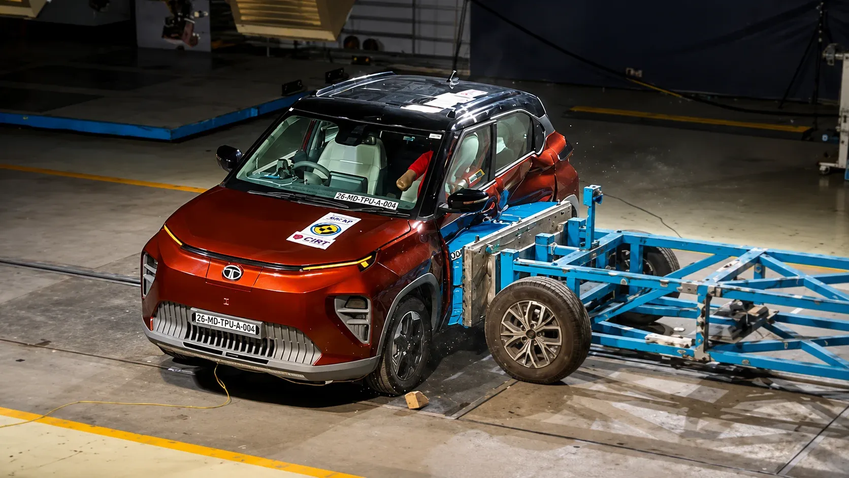 Tata Punch EV facing a deformable barrier during a frontal offset crash test setup
